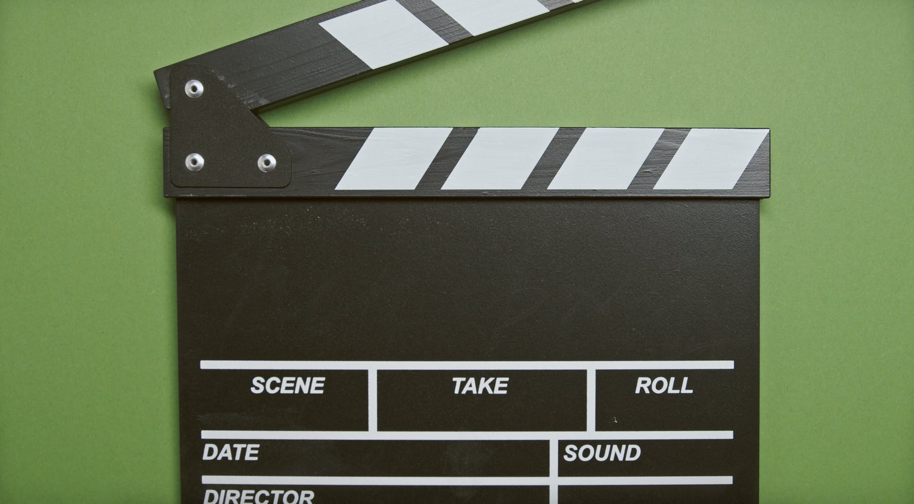 clapper board in green surface